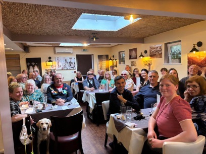 The image is of the inside of Fabio's where tables are full of people all celebrating a successful night of fundraising.